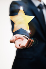 cropped view of businessman in suit with outstretched hand near star on white, quality concept
