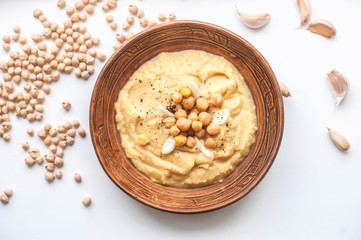 homemade hummus in a clay bowl. top view