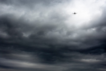 Fototapeta na wymiar Plane taking off in the middle of a stormy sky