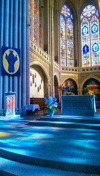 magnificent interior, bluish reflections of the stained glass windows of the Basilica of Notre-Dame de Pontmain, France.