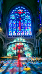 Red cross, and blue reflections of the stained glass windows of the Basilica of Notre-Dame de...