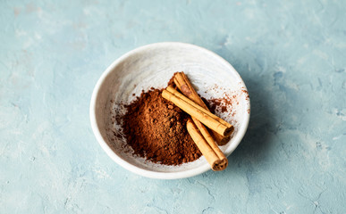 Ceylon cinnamon sticks and cocoa powder in a bowl