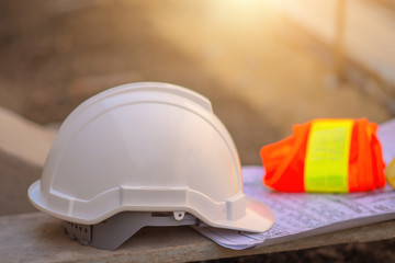 Hard hat on wooden board and blueprint building construction estate project development