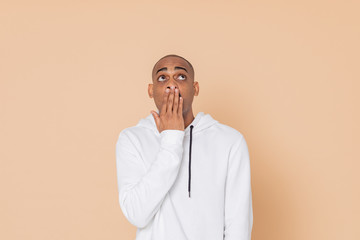 Pensive African guy with a white sweatshirt