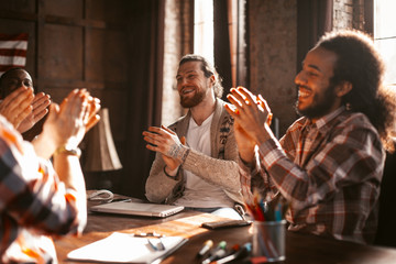 Ovations Of A Multi-Ethnic Group Of Partners In Loft-Style Office, Diverse Team Of Employees Happily Applauds In Unity Celebrating A Successful Project.