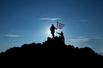 Two soldiers raise the Greek flag