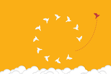 Think differently concept. Be different. Red bird changing direction. New idea, change, trend, courage, creative solution, innovation and unique way concept.	