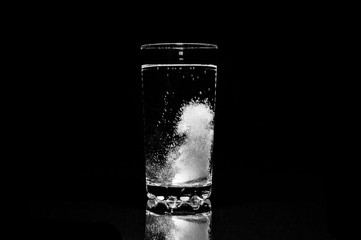 Aspirin dissolves in a glass of water.