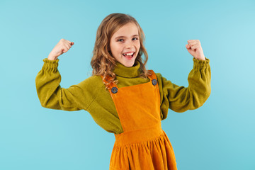 Photo of amusing blonde girl showing her biceps and smiling