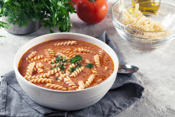 Tomato soup with fusilli pasta in the bowl