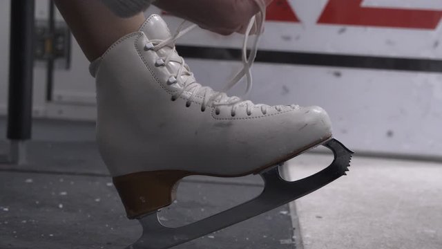 Girl Tying Laces Of Ice Skates