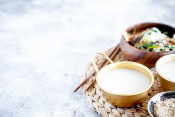 Obraz na płótnie Canvas Makgeolli rice wine is one of the oldest korean traditional fermented alcoholic drinks close-up. Healthy asian boozy beverage. Horizontal orientation, copy space. Selective focus