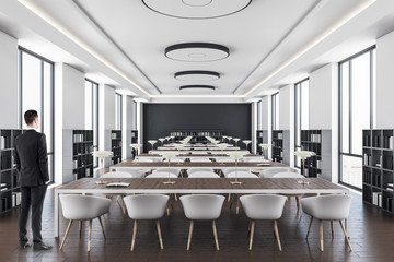 Businessman standing in library interior