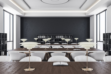 Table with book and lamp in contemporary library interior