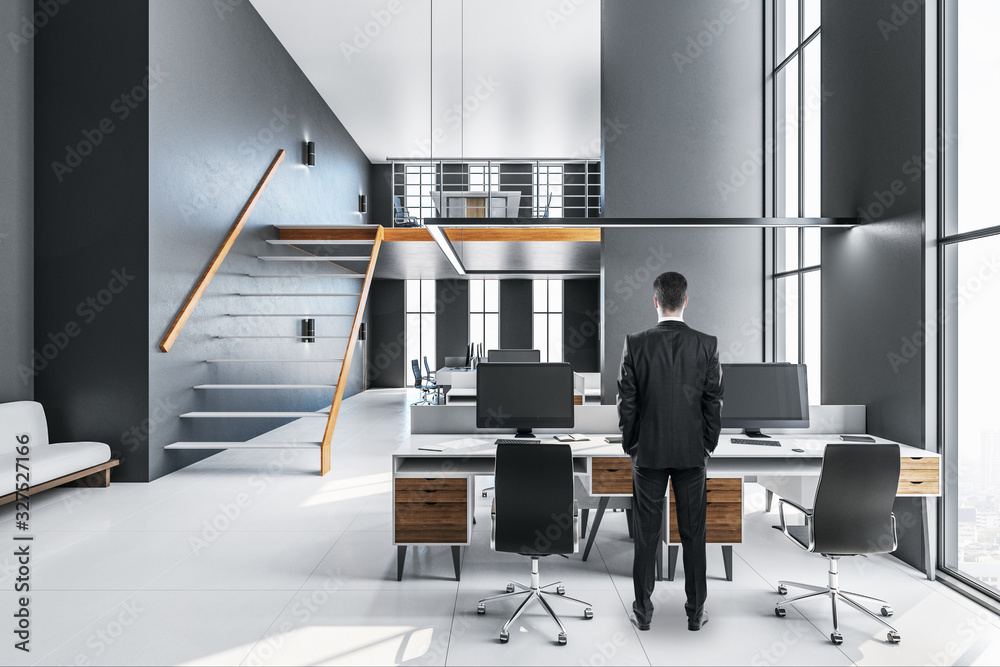 Sticker businessman standing in office interior