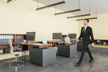 Businessman walking in office interior