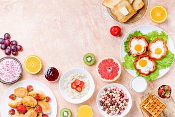 Continental breakfast with cereal, fried eggs, croissants, fruits and drinks on textured table, copy space. Table top with various healthy snacks and foods on rustic background