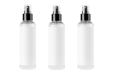 Tall transparent spray dispenser bottles for cosmetics product collection in a row with white label, isolated, mock up for design.