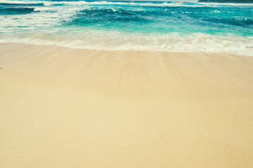 Fototapeta na wymiar Textured background. Sand and water. Tropical beach.