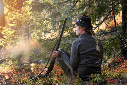 hunter with shotgun and rifle