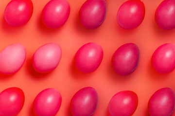 creative layout made of red easter eggs on red background
