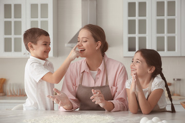 Happy family cooking together in kitchen at home