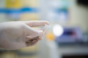 Close up hand hold test-tube of blood.