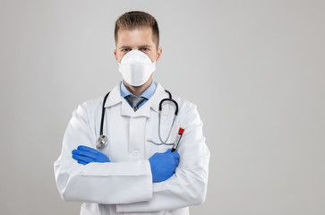Fototapeta na wymiar Health worker wearing a respiratory mask, holding the Coronavirus Covid-19 blood bample,