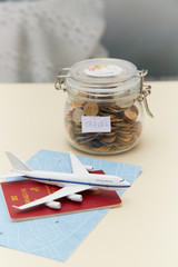 Passport, toy, plane and money bank