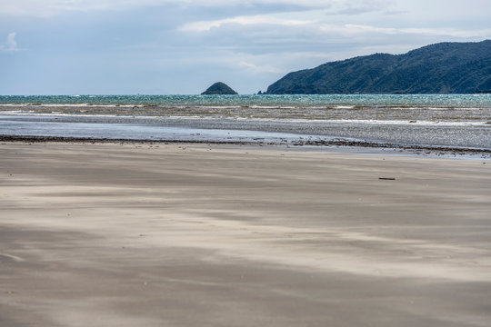waves of Cook strait and Kapiti island in distance, Paraparaumu beach, Wellington, New Zealand