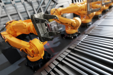 Fototapeta premium Robotic arms along assembly line in modern factory.