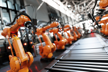 Robotic arms along assembly line in modern factory. © Photocreo Bednarek