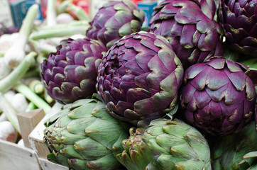 Fresh ripe purple artichokes in the fruit market