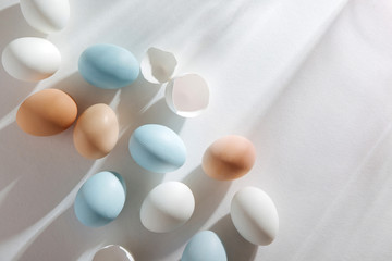 Natural Colored Eggs with morning sunlights. Stylish Compositions in pastel colors.  Easter concept.