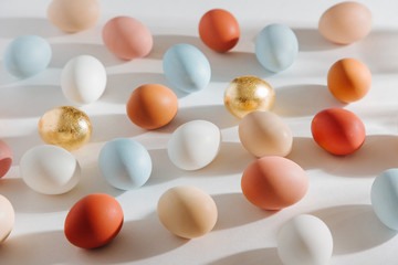 Natural Colored Eggs with morning sunlights. Stylish Compositions in pastel colors.  Easter concept.