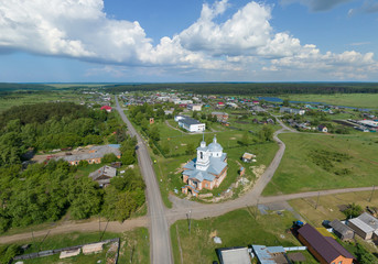 Aerial view of church in Lipovskoe village. A lot of grass and trees. Russia, Sverdlovsk region