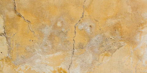 Textured stone sandstone surface yellow concrete wall brown old plaster chipped texture background