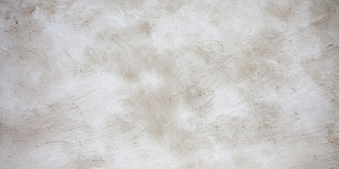 Light white concrete wall as background clouds of brown colors