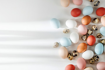Natural Colored brown, quail and white Eggs with sunlights. Compositions in pastel colors. Easter consept.  Flat lay, top view .