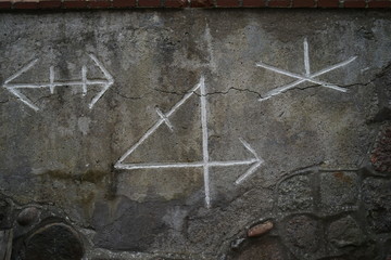 Old viking runes carved in stone above entrance door 