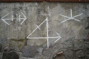 Old viking runes carved in stone above entrance door 