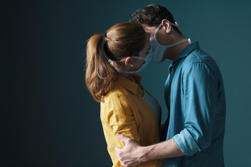 Young loving couple wearing face masks