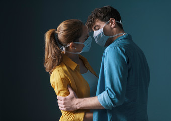 Young loving couple wearing face masks
