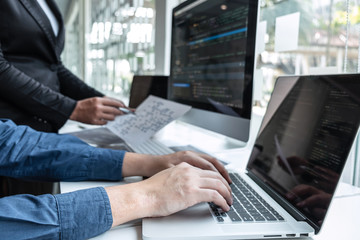 Team of developer programmer working on project in software development computer in IT company office, Writing codes and data code website and coding database technologies to find problem solution