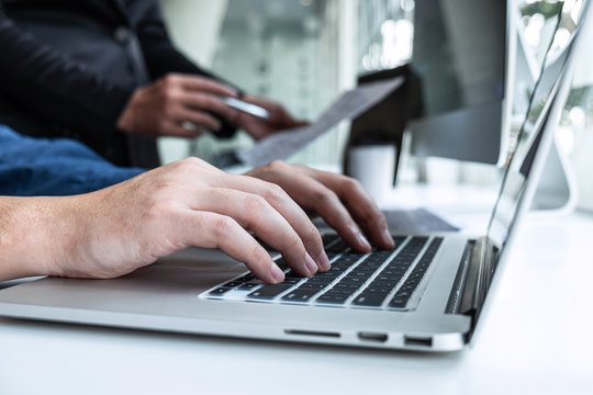 Professional Team of programmer working on project in software development computer in IT company office, Writing codes and data code website and coding database technologies on new Application