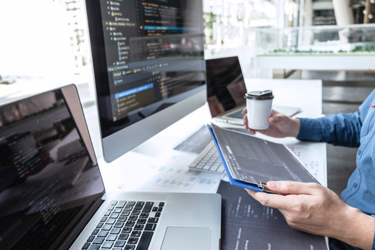 Developer programmer working on project in software development computer in IT company office, Writing codes and data code website and coding database technologies to find solution to problem