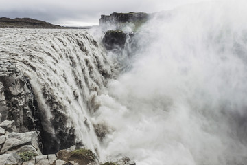 Dettifoss waterfall in Iceland. The most powerful waterfall in Europe. Breathtaking and dramatic view. Close-up view of flowing water stream.
