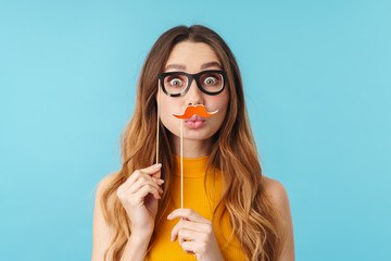 Portrait of joyous caucasian woman wearing paper eyeglasses and mustache