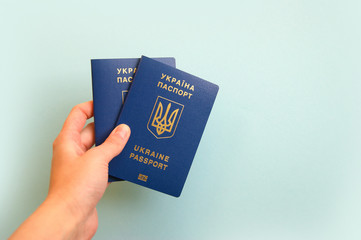 Two Ukrainian biometric passports in a female hand. Travel concept