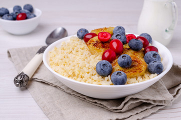 Wheat porridge with fruit and berries